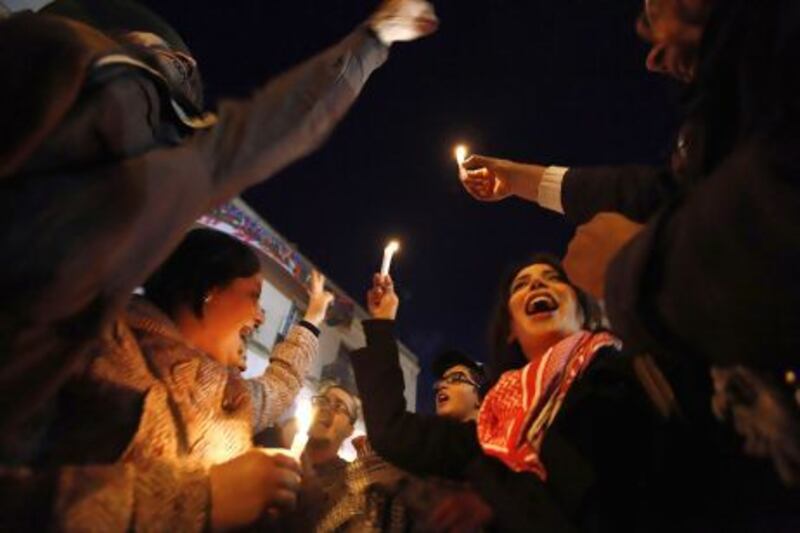 Artists hold candles during a demonstration to show solidarity outside the headquarters of the General Union of Tunisian Workers in Tunis.
