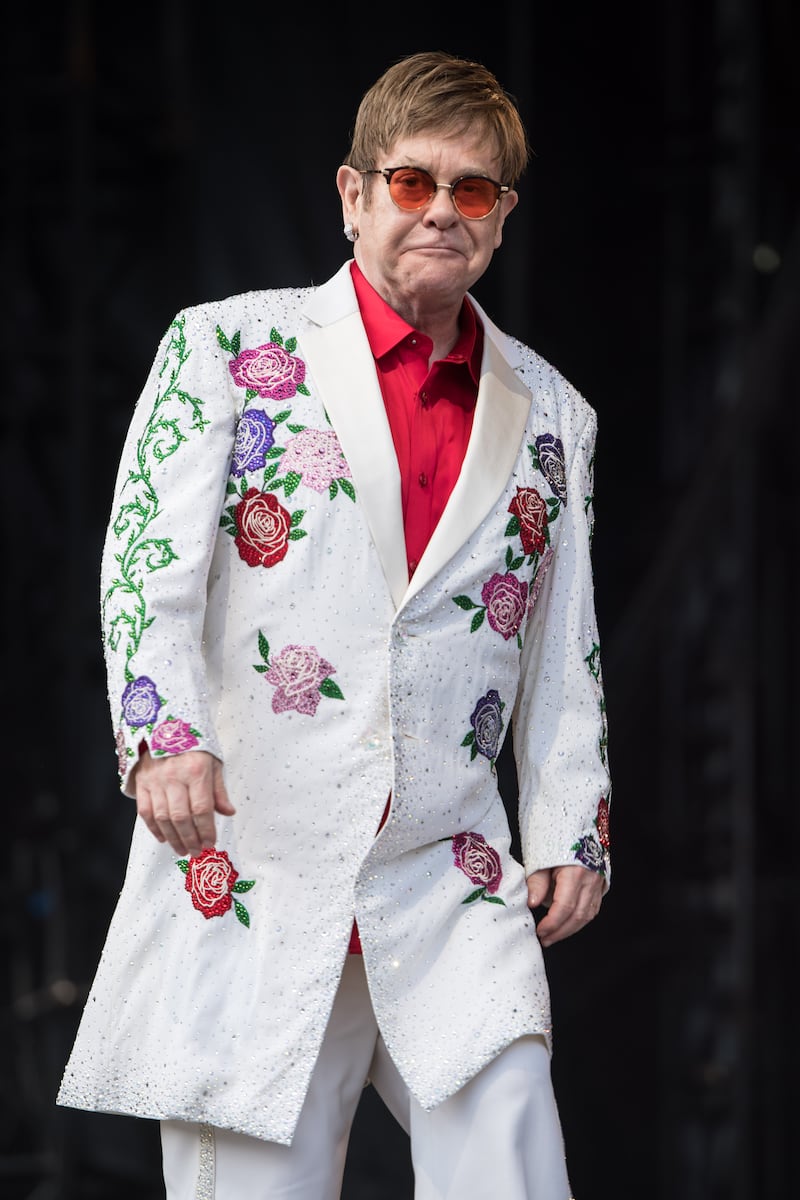 Elton John, in a white suit with a rose pattern, performs live at Twickenham Stoop on June 3, 2017 in London, England. Getty Images