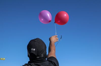A Gaza resident releases incendiary balloons into Israeli territory. EPA