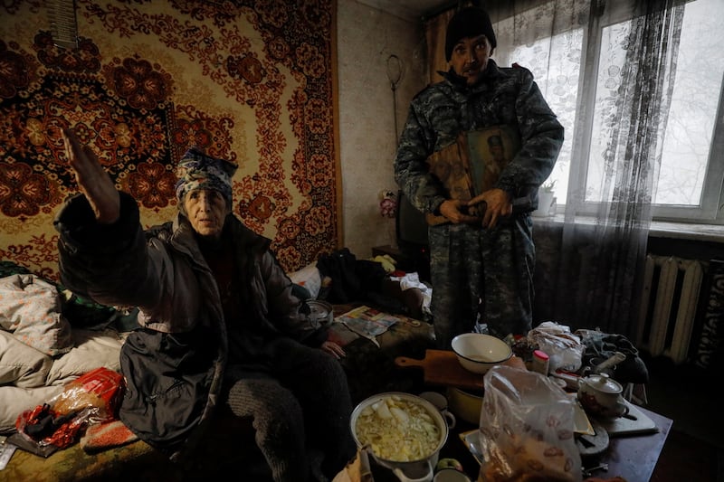 Mr Antonenko and his mother Liudmyla inside their apartment recently damaged by a Russian military strike in Kherson. Reuters