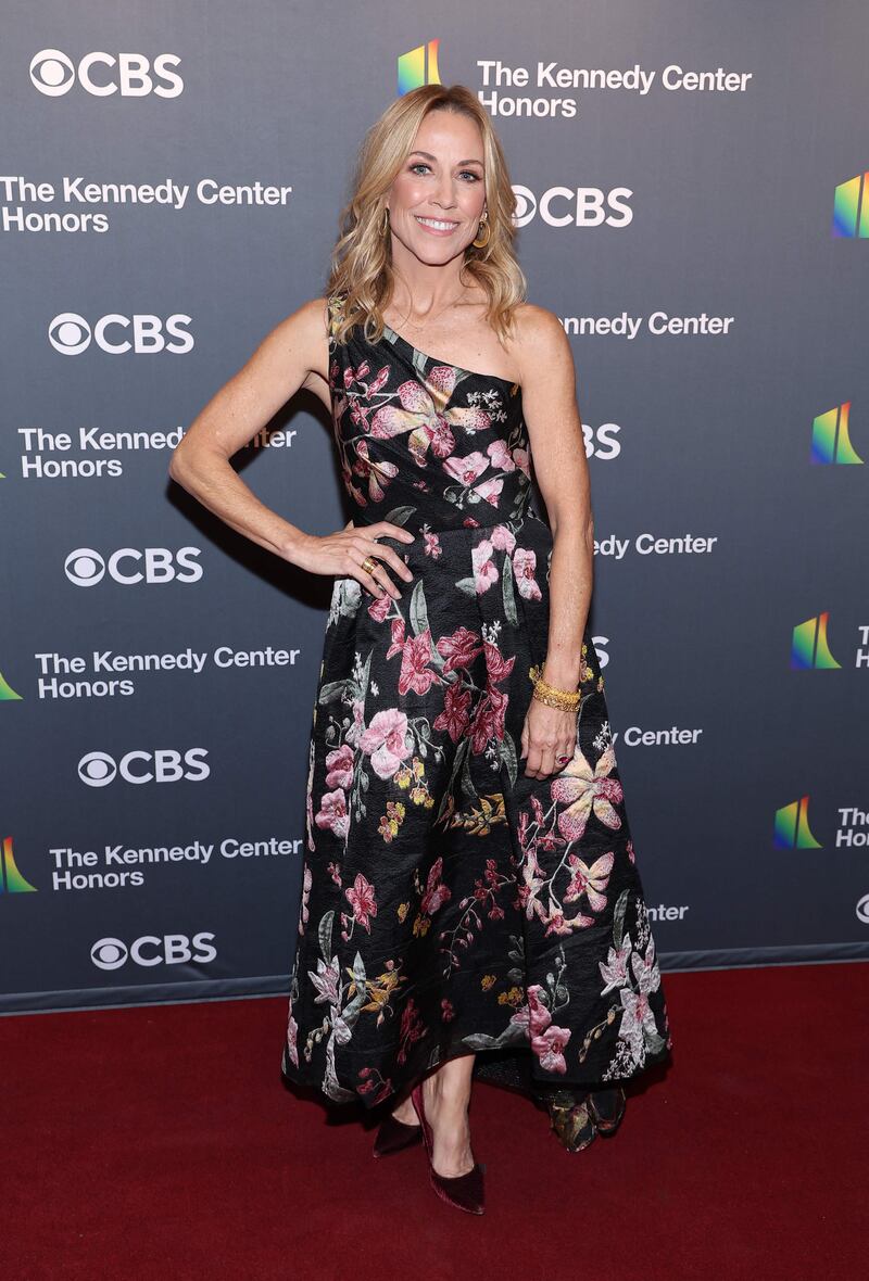 Sheryl Crow wearing a one-shouldered floral dress. Getty Images 