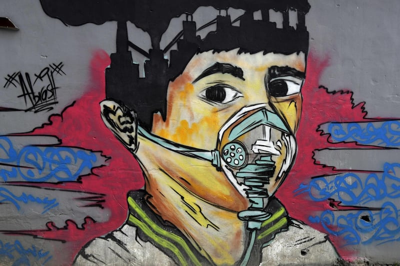 A mural depicts a mask-clad boy in front of the Zouk Thermal Power Plant, north of the Lebanese capital Beirut. AFP