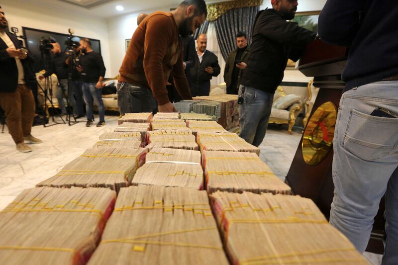 Journalists arrive for a press conference by the head of the Federal Authority of Integrity in Baghdad on January 3, 2023, to announce the recovery of four billion Iraqi dinars, the equivaliant of $2. 6 million, reportedly part of the $2. 5 billion of government funds fraudulently stolen from the tax authorities.  (Photo by Sabah ARAR  /  AFP)