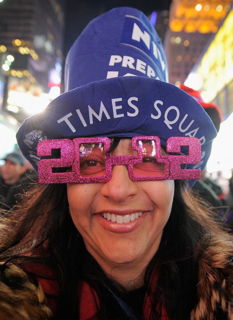 NEW YORK, NY - DECEMBER 31: Giovanna Rodger joins thousands of revelers gathered in New York's Times Square to celebrate the ball drop at the annual New Years Eve celebration on December 31, 2011 in New York City.   Jemal Countess/Getty Images/AFP== FOR NEWSPAPERS, INTERNET, TELCOS & TELEVISION USE ONLY ==
 *** Local Caption ***  560113-01-09.jpg