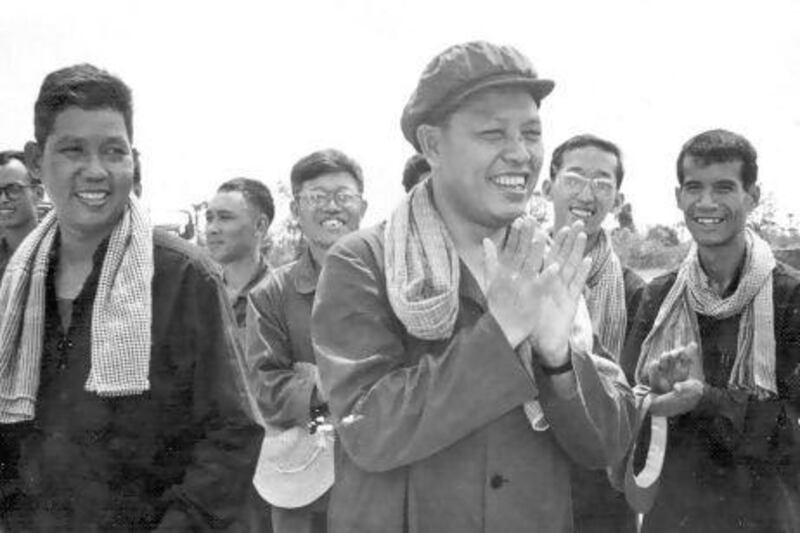 Former Khmer Rouge foreign minister Ieng Sary, centre, claps during an inspection of railway tracks in Takeo province in 1977. The Khmer Rouge co-founder who was on trial for genocide and war crimes, died on March 14.