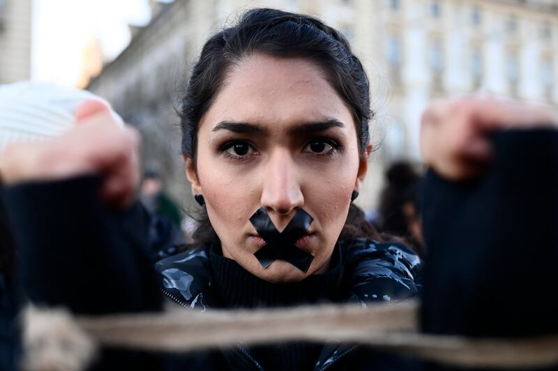 A protester in Turin, Italy expresses her solidarity with Iranian demonstrators after the death of Mahsa Amini in custody. Getty
