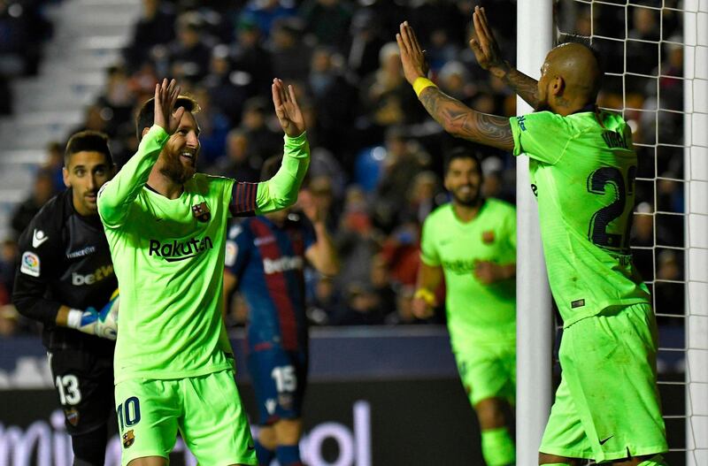 Lionel Messi celebrates after scoring a goal with Arturo Vidal. AFP