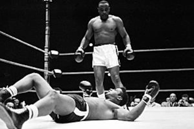 Sonny Liston stands over heavyweight champion Floyd Patterson after knocking him out in the first round of the title fight in 1962.