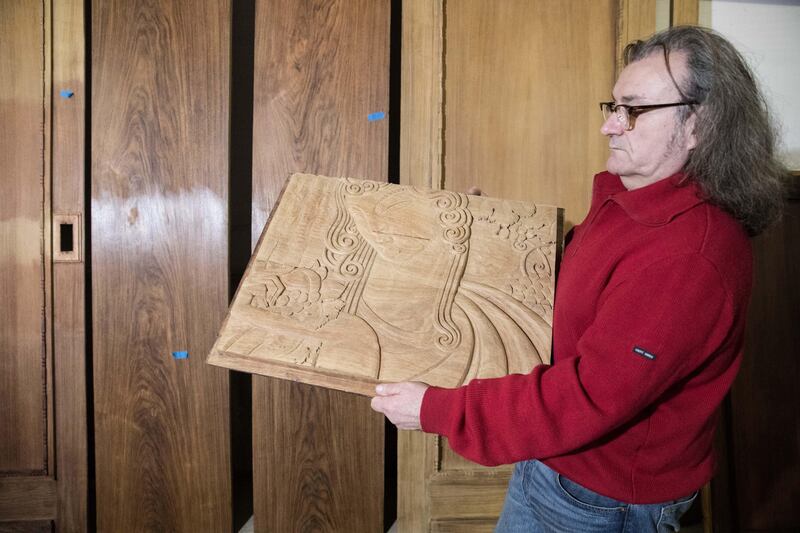 Christophe Morin / IP3 . Wood expert Thierry Palanque holds a Carved wooden drawing in a restoration workshop on February 9, 2017 in Saint Remy, France, which is installed a decor of Ruhlmann office renovation to be presented at the Louvre Abu Dhabi During the year 2017. 
Picture: Christophe Morin for The National