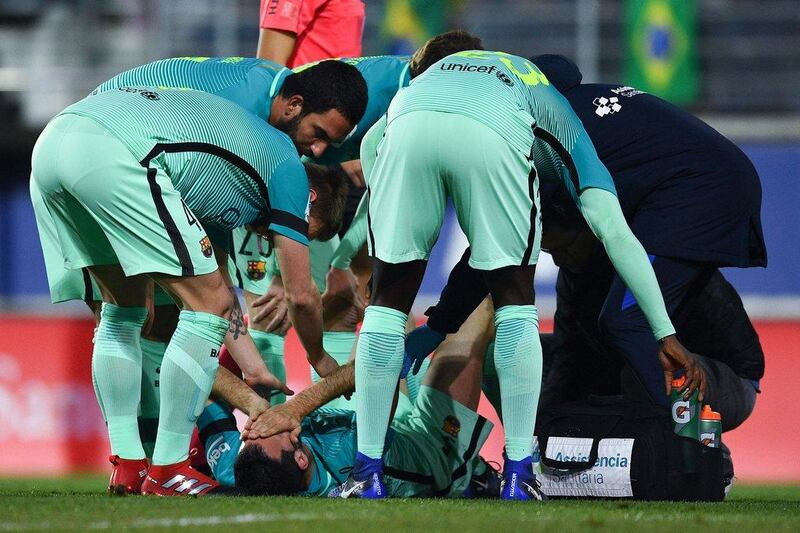 Barcelona's Sergio Busquetsis attended to by teammates on the pitch after being injured  against Eibar on January 22, 2017 in Eibar, Spain. David Ramos / Getty Images