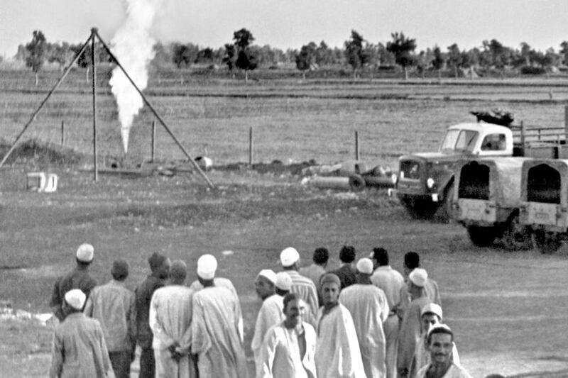 Egyptian farmers look at a towering flame at an outburst of natural gas discovered by Eni in this 1966 photo. Aly Mahmoud / AP Photo