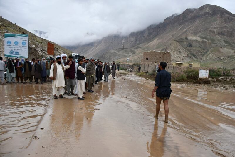 Afghan people gather along the road between Samangan and Mazar-i-Sharif following a flash flood in the Feroz Nakhchir district of Samangan province. AFP