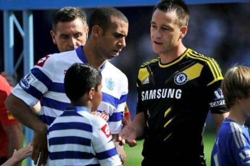 Anton Ferdinand, left, the QPR defender, avoids shaking hands with Chelsea's John Terry who was cleared of a racism charge from last season. Glyn Kirk / AFP