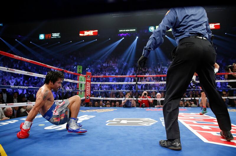 Manny Pacquiao, from the Philippines, lifts himself from the canvas as referee Kenny Bayless stands by after being knocked down in the third round of his WBO world welterweight fight against Juan Manuel Marquez, from Mexico,  Saturday, Dec. 8, 2012, in Las Vegas. (AP Photo/Eric Jamison) *** Local Caption ***  Pacquiao Marquez Boxing.JPEG-05afa.jpg
