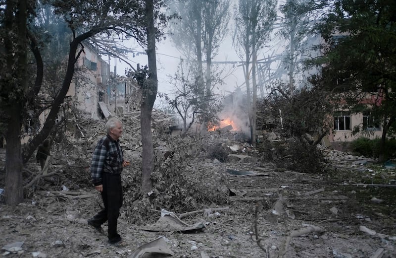 A man walks in front of a damaged school after a missile strike hit the city of Kramatorsk. EPA 