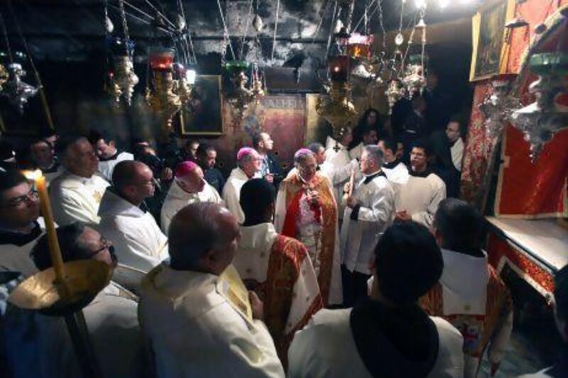 Clergy pray in the 'Grotto', where Christians believe the Virgin Mary gave birth to Jesus Christ, in the Church of the Nativity, in the West Bank town of Bethlehem.