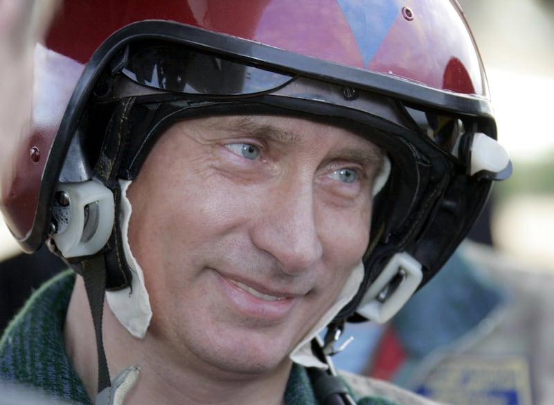 Putin poses for a picture after his arrival at Olenogorsk military airport, near Murmansk on August 16, 2005. AFP
