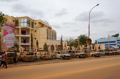 Burnt-out vehicles outside the Nigerien Party for Democracy and Socialism HQ in Niamey, Niger. EPA 