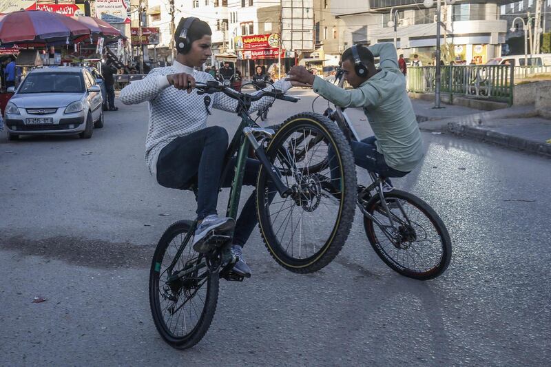 Palestinian youths showcase their acrobatic skills on their bicycles in Rafah in the southern Gaza Strip. AFP