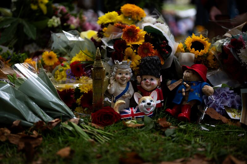 Flowers and tributes, including sunflowers and a Paddington Bear, are left for Queen Elizabeth at the Green Park memorial in London. AP