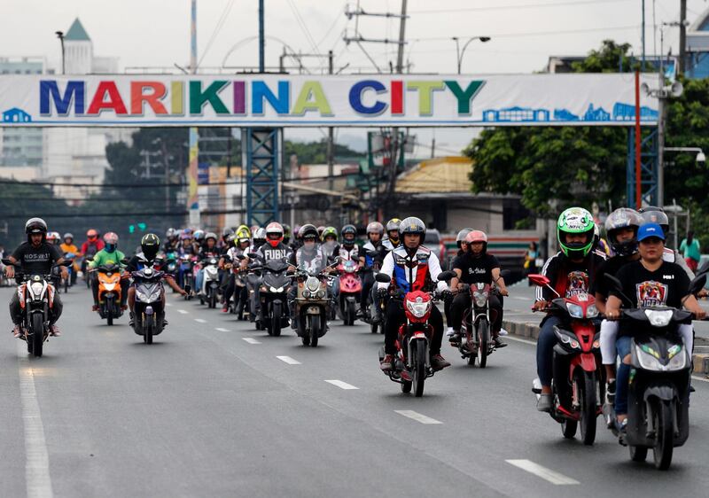 Filipino motorcycle riders take part in a a relief operation after floods hit the city of Marikina, east of Manila. EPA