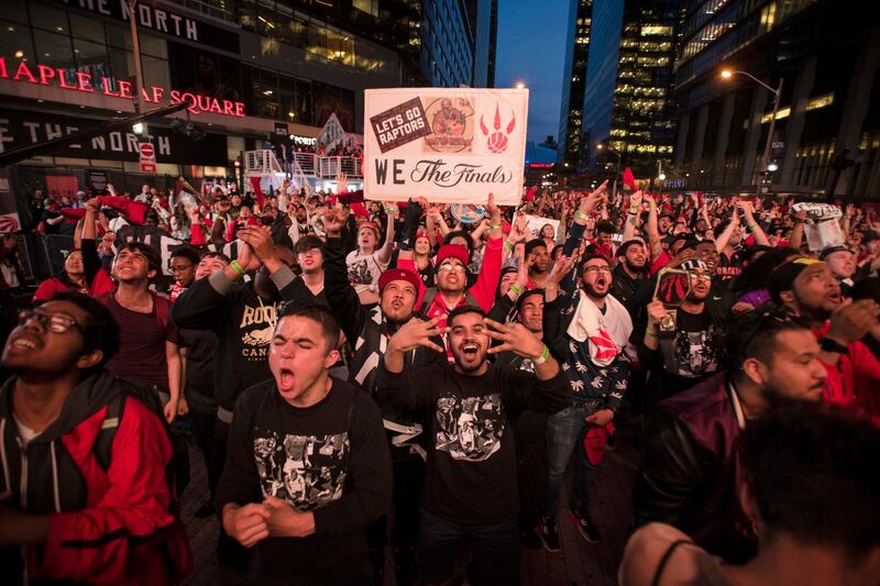 Toronto Raptors fans react in "Jurassic Park" outside Scotiabank Arena after the Raptors made their first basket. AP Photo