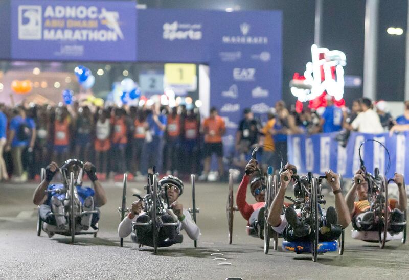 ABU DHABI, UNITED ARAB EMIRATES- Paraathletes in a wheelchair participating in the marathon at the ADNOC ABU Abu Dhabi Marathon.  Leslie Pableo for The National 