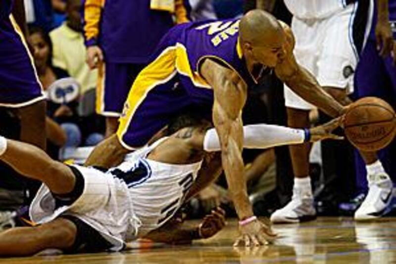 Derek Fisher scrambles for the ball with Orlando's Jameer Nelson during the LA Lakers' 99-91 victory.
