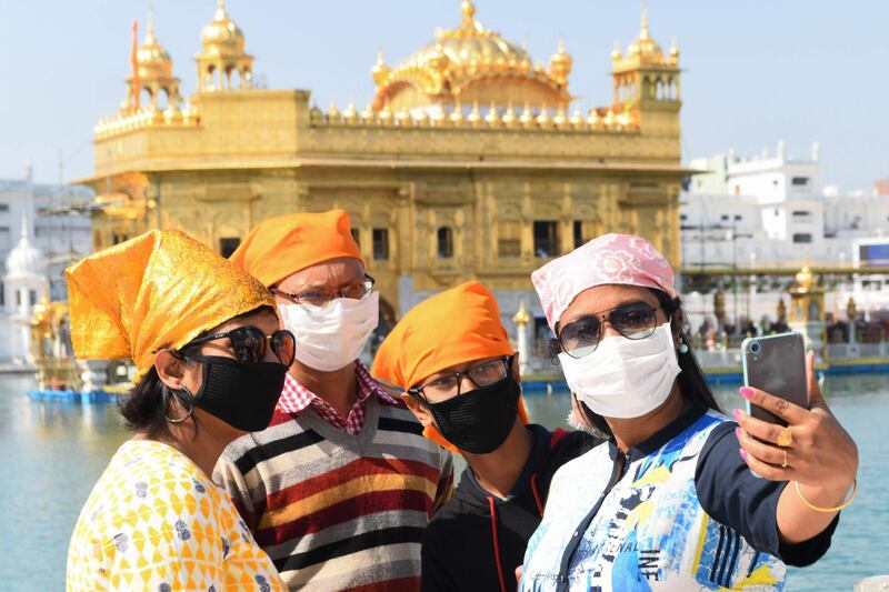 Devotees take a selfie at the Golden Temple in Amritsar.  AFP