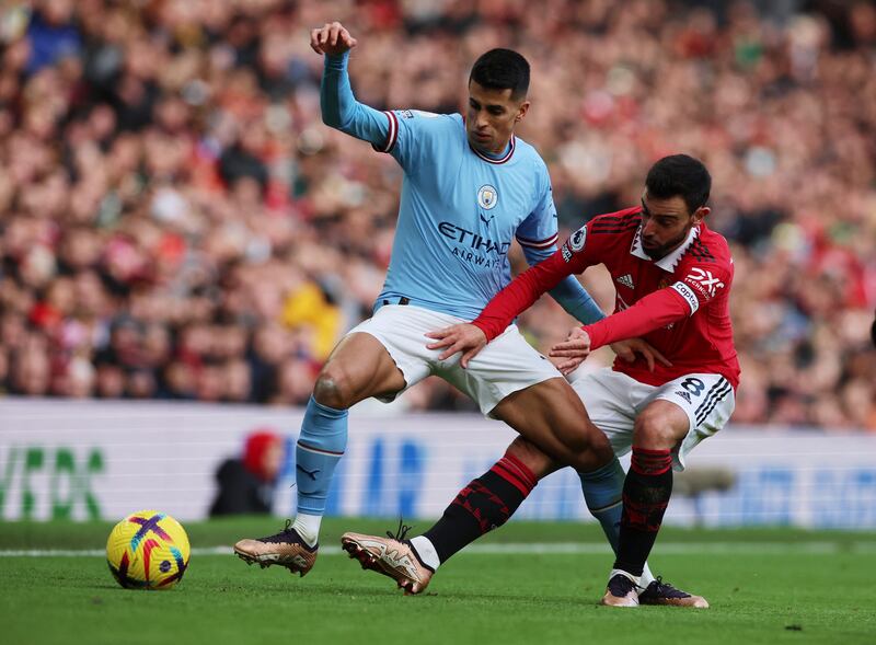 Manchester City's Joao Cancelo in action with Manchester United's Bruno Fernandes. Reuters