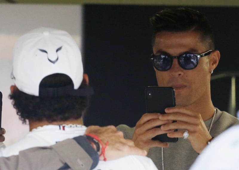 Ronaldo gets a photograph with Hamilton. AP Photo
