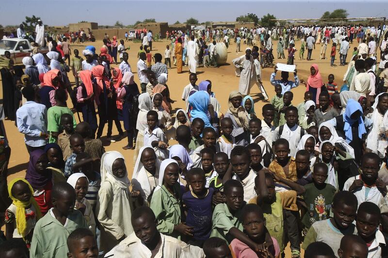 Displaced Sudanese wait for the arrival of Sudan's prime minister at a camp for internally displaced people (IDP) in El-Fasher, the capital of the North Darfur state. AFP
