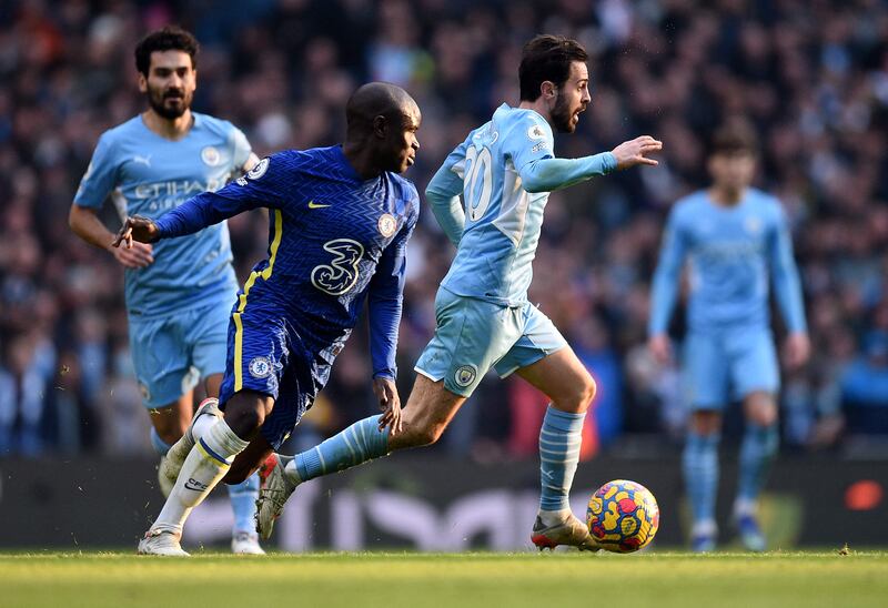 Manchester City midfielder Bernardo Silva runs with the ball as N'Golo Kante attempts to close him down. AFP