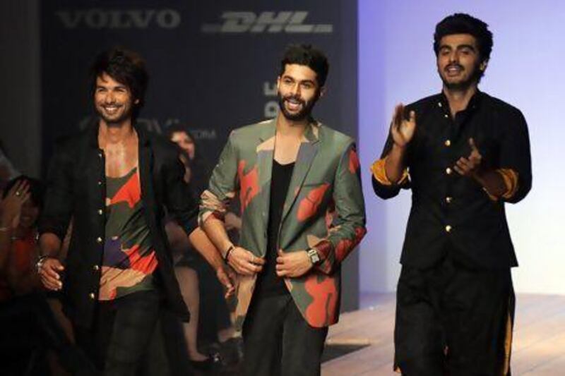 Lakme Fashion Week's star power included, from left, Shahid Kapoor, the designer Kunal Rawal and Arjun Kapoor. PUNIT PARANJPE / AFP