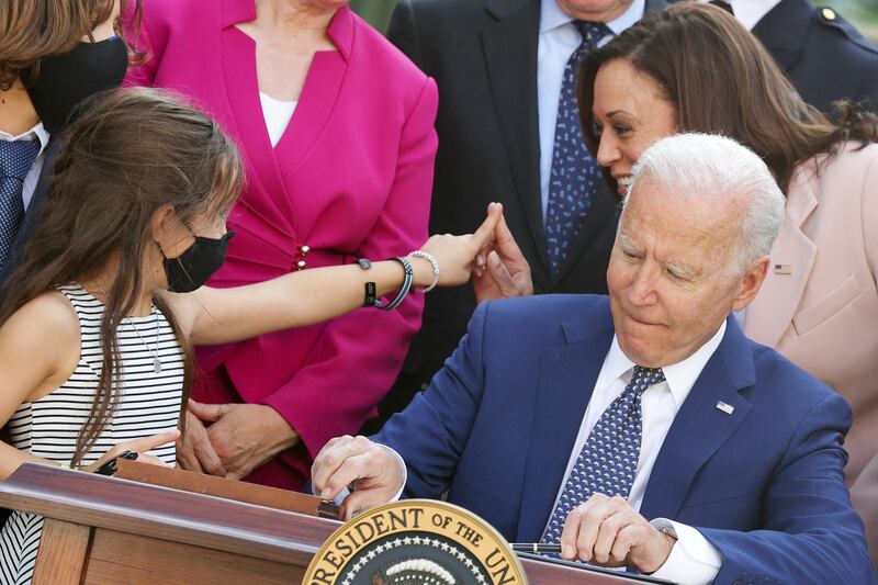 Kamala Harris‬ and Joe Biden interact with family members of fallen police officers as Mr Biden signs into law an act to award four Congressional Gold Medals to the US Capitol Police, Washington Metro Police and those who protected the Capitol on January 6. Reuters