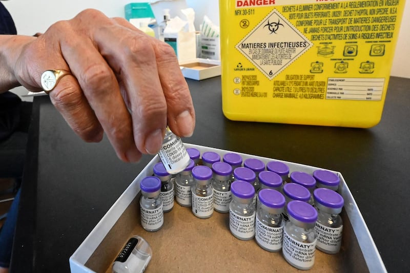 A nurse puts a vial in a box as she prepares doses of the Pfizer/BioNTech vaccine against Covid-19 during a vaccination campaign at the city hall of Montpellier, southern France on April 15, 2021, aimed at stemming the spread of the Covid-19 pandemic.  / AFP / Pascal GUYOT
