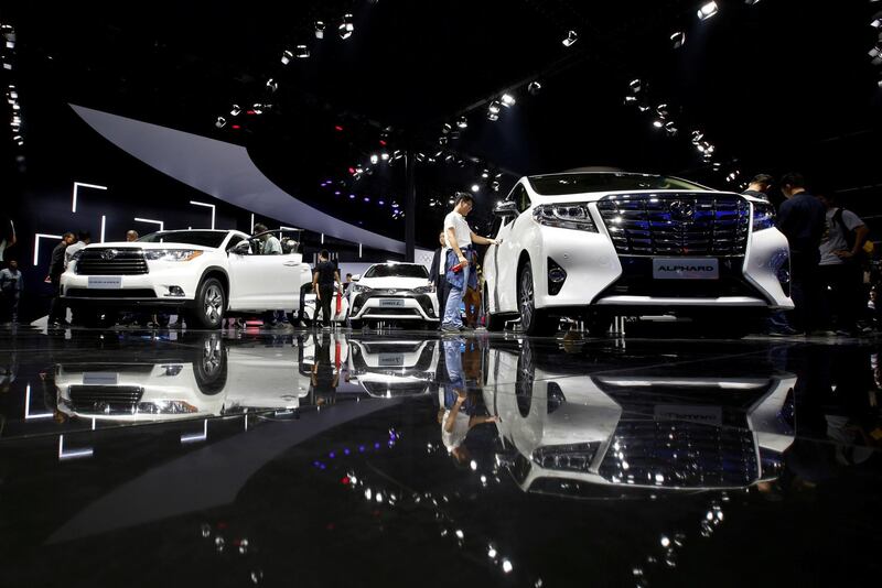 FILE PHOTO: Visitors look at Toyota models at Auto Guangzhou in Guangzhou, China November 17, 2017.      REUTERS/Bobby Yip/File Photo