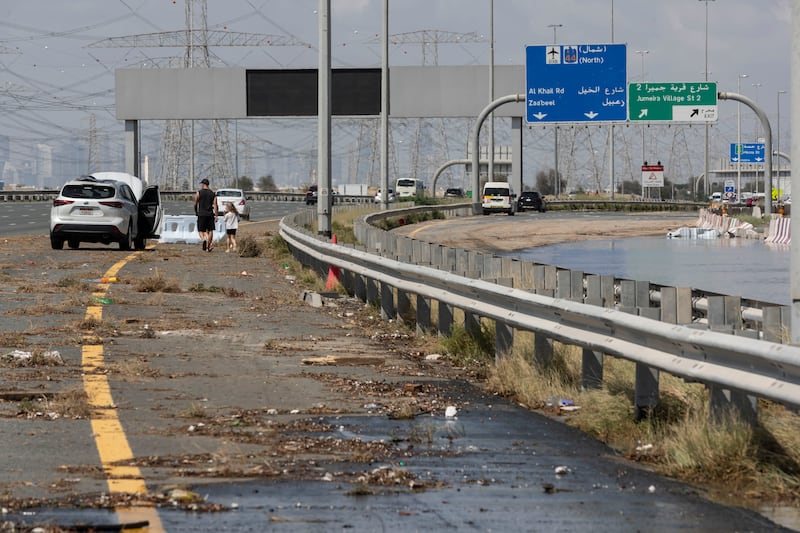The aftermath of heavy flooding in Dubai, with debris and abandoned cars on the street. Antonie Robertson / The National