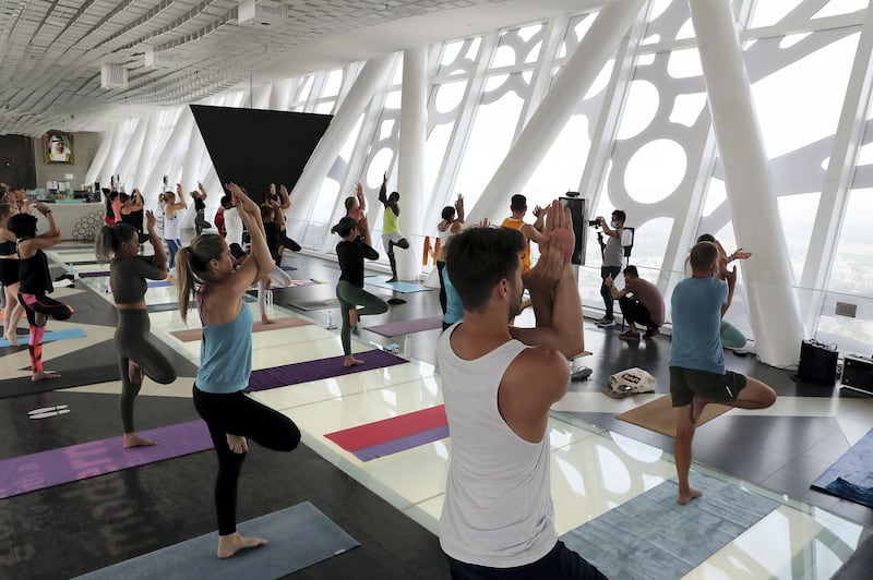 DUBAI, UNITED ARAB EMIRATES , August 12 – 2020 :-  Participants during the Yoga Class taken by the Nitai Krishna on the glass bottomed part of the Dubai Frame in Dubai. Total 30 participants took part in the morning yoga, which started from 7:30 am to 8:30 am. This is a part of Dubai Summer Surprise.  This is a part of Dubai Summer Surprise. (Pawan Singh / The National) For Arts & Culture/Online/Instagram. Story by Evelyn