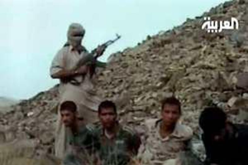 An image grab taken from footage broadcast on June 20, 2008 on Al-Arabiya news channel allegedly shows an Iranian Jundallah fighter with a rifle standing over kidnapped Iranian security workers in an unidentified place. The Iranian Sunni Muslim rebel group Jundallah claims to have executed two of 16 Iranian security workers it says it kidnapped last week, Al-Arabiya reported today. The Dubai-based news channel aired a brief film showing two men kneeling in front of an armed man, his weapon aimed at the pair, and said that they had been executed. AFP PHOTO/DSK == RESTRICTED TO EDITORIAL USE - QATAR OUT ==