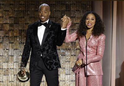 Kevin Frazier and Nischelle Turner accept the outstanding entertainment news series award. AFP