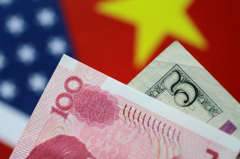 FILE PHOTO: U.S. Dollar and China Yuan notes are seen in this picture illustration June 2, 2017. REUTERS/Thomas White/Illustration/File Photo