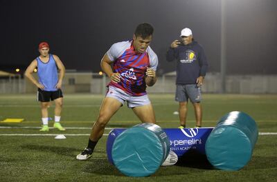 Noah Perelini, centre, during a rugby training session with his father Apollo Perelini, right, at Repton school in Dubai in January 2017. Pawan Singh / The National