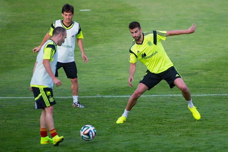 Spain players Gerard Pique, right, David Silva, back, and Andres Iniesta, front, train on Monday for the 2014 World Cup. David Ramos / Getty Images / May 26, 2014