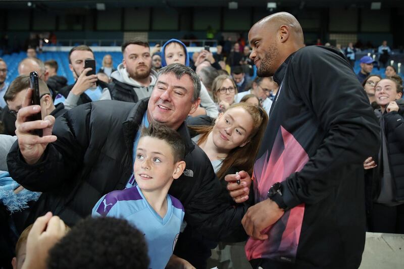 Vincent Kompany poses with fans for a picture after the match. Reuters