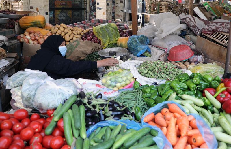 A vendor wears a mask at fruit and vegetable shop in Cairo, Egypt.  EPA