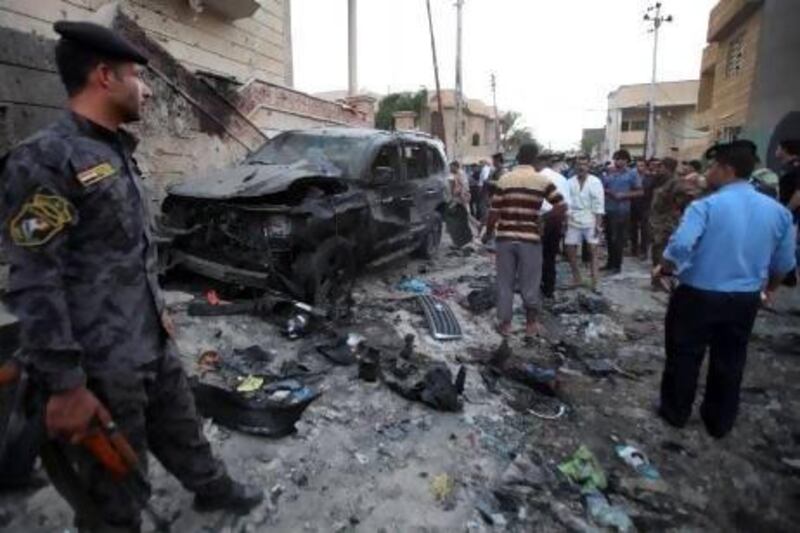 Security forces inspect the scene of a car bomb attack in Basra,  550 kilometres southeast of Baghdad.