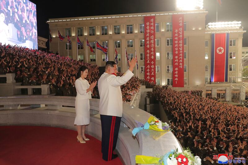 North Korean leader Kim Jong-un and his wife Ri Sol-ju at a military parade in Pyongyang to mark 90 years since North Korea's army was established. AP