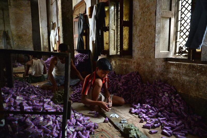 A young labourer packs bidis into colourful conical packets and boxes at The New Sarkar Bidi Factory in Kannauj, some 200kms south-east of New Delhi.