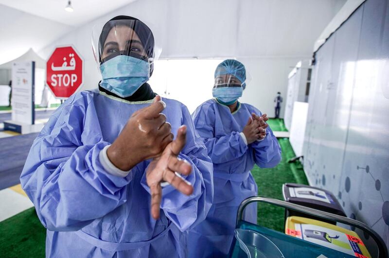 Dubai, United Arab Emirates, April 12, 2020.  The National Screening Center, Mina Rashed, Dubai.  Nurse Asmahan Bin Thabet Al Nahdi sanitizes her hands after conducting a swab test.
Victor Besa / The National
Section:  NA
Reporter:  Nick Webster